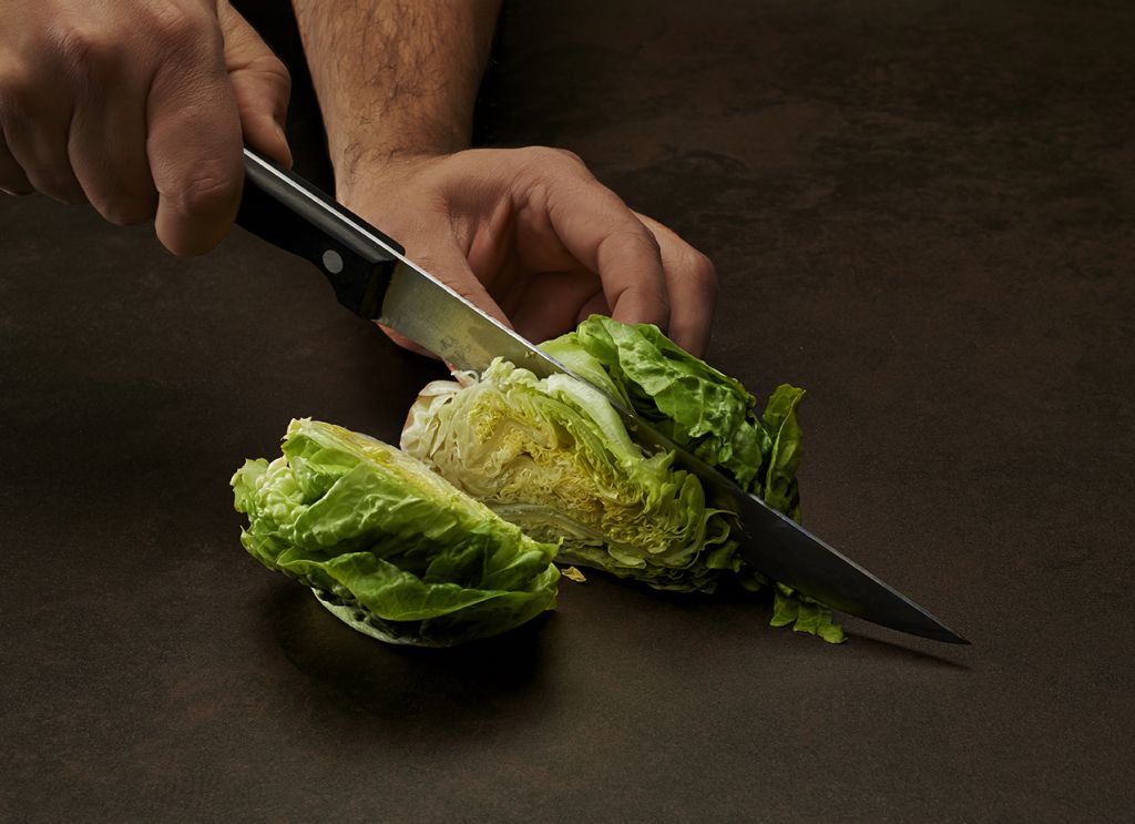 Sharp knife cutting on granite worktop