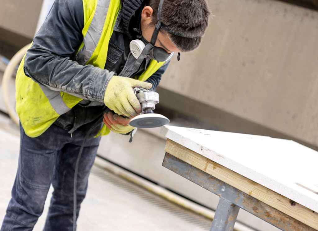 Factory Worker Polishing Granite